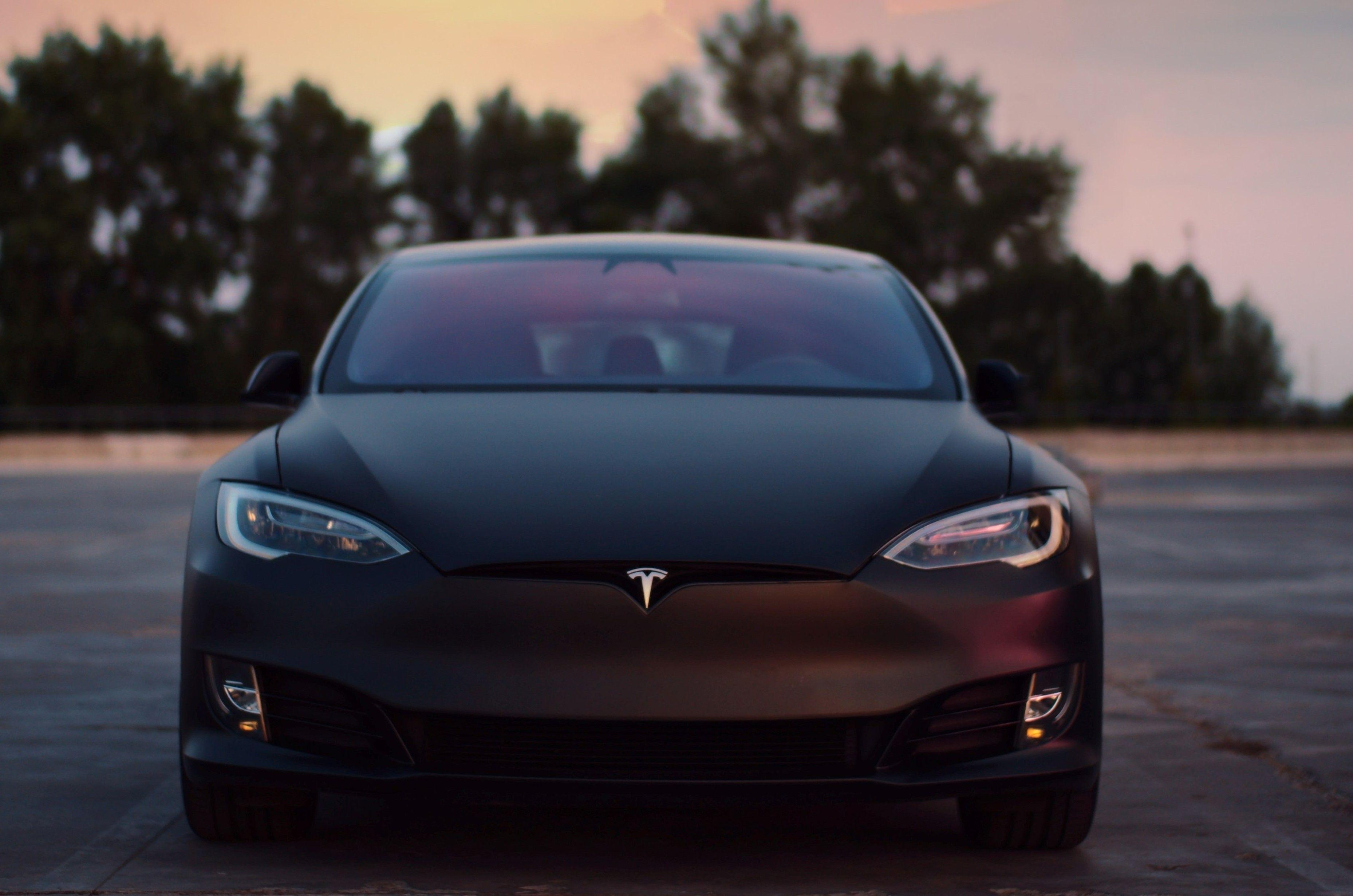 Tesla electric car on pavement.